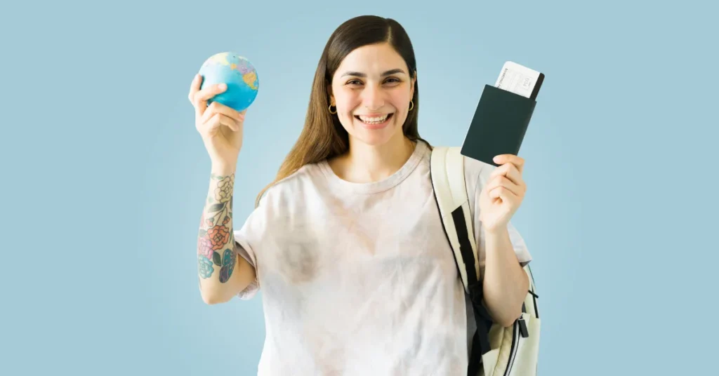 woman's both hands on globe and passport