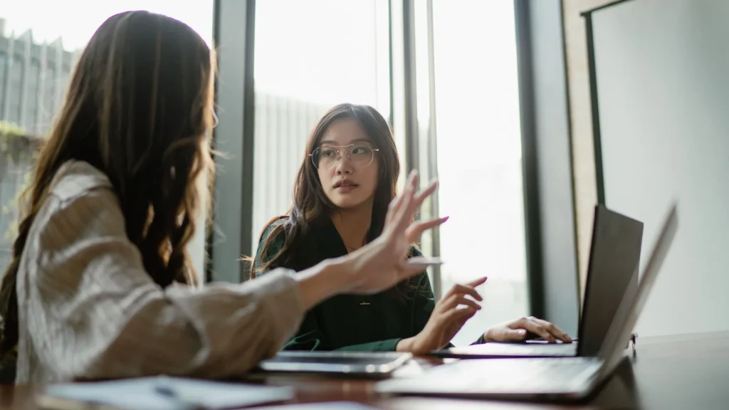 Student discussing pay or work responsibilities in a professional setting